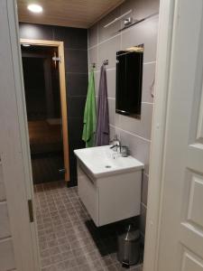 a bathroom with a white sink and a mirror at Ammatour Apartments in Uro