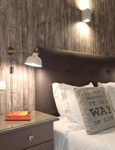 a bedroom with a bed with a wooden wall at Apart Great Sea View in Alvor