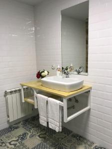 a bathroom with a sink and a mirror at CASA DA LABORA in Villanueva de Arosa +7 photos