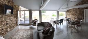 a living room with a couch and chairs and tables at CASA DA LABORA in Villanueva de Arosa