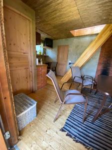 a living room with two chairs and a rug at Mooni Cottage in Pärnu +19 photos