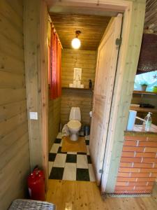 a bathroom with a toilet in a wooden cabin at Mooni Cottage in Pärnu