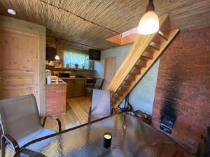 a room with a table and chairs and a staircase at Mooni Cottage in Pärnu