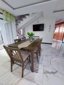 a dining room with a wooden table and chairs at Serenity Cove - A Home Away From Home in Bel Ombre
