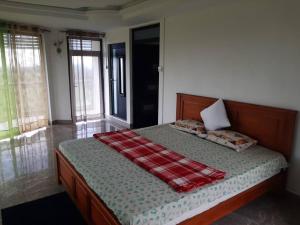 a bedroom with a bed with a blanket on it at Serenity Cove - A Home Away From Home in Bel Ombre