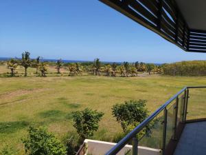 a view of a field from the balcony of a house at Serenity Cove - A Home Away From Home in Bel Ombre