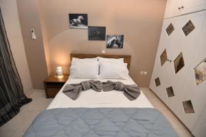 a bedroom with a bed with a bow on it at Eva's Garden House in Ialyssos