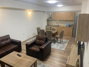 a living room with a couch and a table and a kitchen at Apartment Trifunovi in Kočani