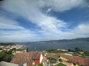 a view of a large body of water with buildings at O Castro Sanxenxo in Sanxenxo