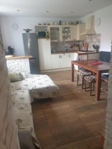 a kitchen and dining room with a table and chairs at Apartman Diana in Boldogkőváralja