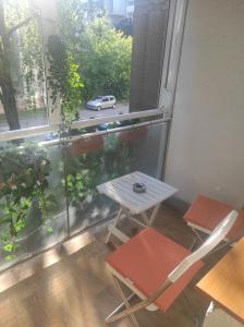 a table and chairs in a room with a window at Astralis Factory Apartments- Max in Zagreb