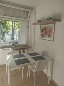 a table and chairs in a room with a window at Astralis Factory Apartments- Max in Zagreb