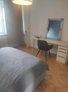 1 dormitorio con escritorio, 1 cama y 1 silla en Astralis Factory Apartments- Max, en Zagreb