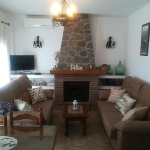 a living room with a couch and a fireplace at Casa Ana, Fantásticas vistas a Frigiliana, el mar y la montaña in Frigiliana