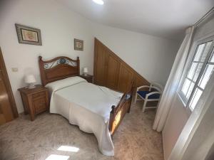 a bedroom with a large bed and a window at O Castro Sanxenxo in Sanxenxo +11 photos