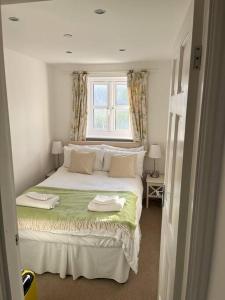 a bedroom with a large bed with two towels on it at Beau retreat lovely apartment in Beaumaris in Beaumaris
