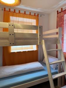 two bunk beds in a room with a window at MemmingenBuxheimKartause in Buxheim