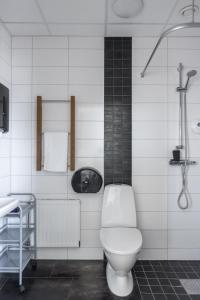 a white bathroom with a toilet and a sink at Hotell Hamnen in Färjestaden