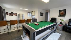 a living room with a pool table in it at Spacious, Cheerful, Modern Home 5 BR, 3BA, 2KIT in Shoreline