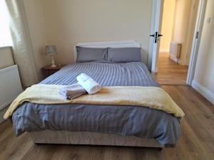 a bedroom with a bed with two towels on it at Radharc an tSléibhe - Mountain View - Eircode F92R2R8 in Letterkenny