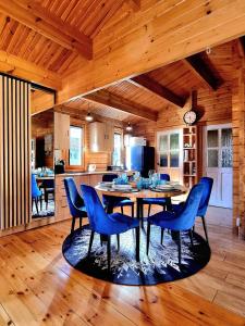 a kitchen and dining room with a table and chairs at Leśna ostoja Poddąbie in Poddąbie +48 photos