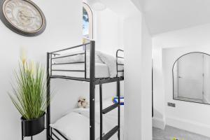 a black bunk bed in a room with a mirror at Rutland Heights - Luxury Apartment in Torquay