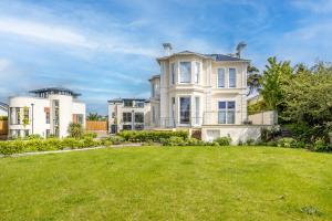 a large white house with a large yard at Rutland Heights - Luxury Apartment in Torquay