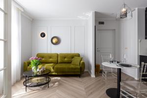 een woonkamer met een groene bank en een tafel bij Fresh unit, high quality design. in Tallinn