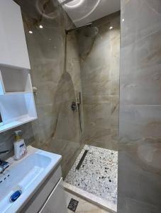 a bathroom with a shower and a sink at Studio City Center in Tirana