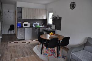a kitchen with a table and chairs in a room at Villa Pliva Lake Jajce in Jajce