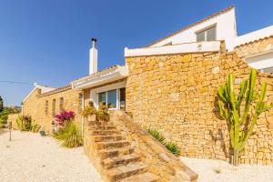 a stone house with a stone wall at Mediterranean villa in Calpe with private pool. in Calpe
