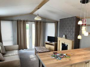 a living room with a couch and a table at Marsh Farm Holiday Park in Great Yarmouth