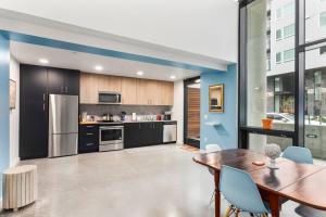a kitchen with a wooden table and a dining room at Open Loft in Redmond Core - 92 Walkscore! in Redmond
