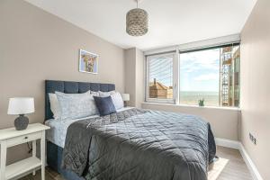a bedroom with a bed and a window at Airhost's Brighton's Best Green Diamond Escape with Sea Views in Brighton & Hove