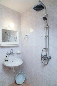 a bathroom with a sink and a toilet and a shower at Ravda Bay Guest House in Ravda
