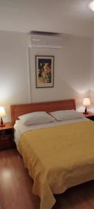 a bedroom with a large bed with two lamps at Villa Ruzica in Trogir