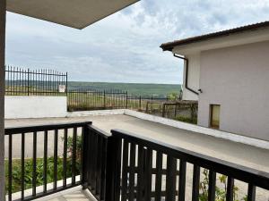 a balcony with a view of the ocean from a house at Apartments in complex Harmony hills in Rogachevo