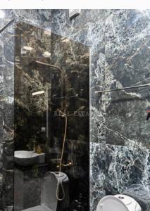 a marble bathroom with a toilet and a sink at Saryan 2 in Yerevan