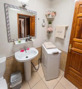 a bathroom with a sink and a toilet and a mirror at Casas del Sol in Playa Blanca