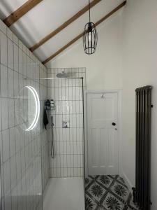 a bathroom with a shower with a glass door at Stylish Unique 3 Bedroom House Hastings in Hastings +20 photos