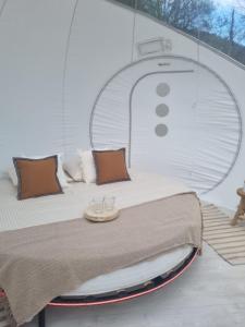 a bed on a boat with a table on it at Camping les lodges du Tarn in Mostuéjouls
