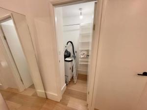 an empty room with a hallway with a door to a room with a closet at Beautiful brand-new flat in London