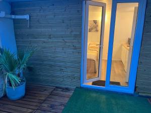 a sliding glass door leading to a bathroom with a bedroom at Abrilove in Castres