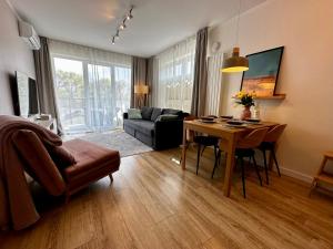 a living room with a table and a couch at Apartament Słoneczny Dziwnów in Dziwnów