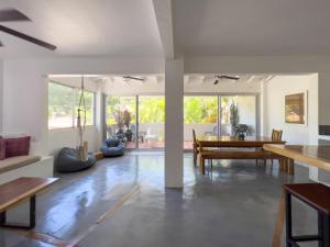a living room with a table and a dining room at Salt Nosara in Nosara