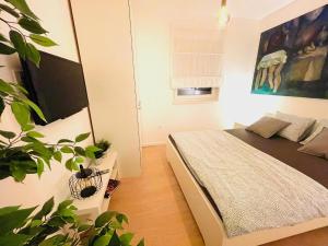 a bedroom with a bed and a potted plant at Anapartments2 in Primošten