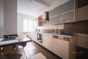 a kitchen with a sink and a counter top at Apartament Best Rest in Wadowice