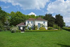 a white house with a yard with a green lawn at River Views, Beccles - HOT TUB + Norfolk Broads in Beccles