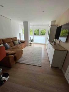 a living room with a couch and a table at Precioso apartamento recién reformado in Gijón