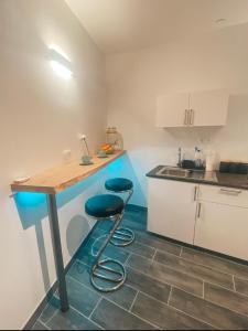 a kitchen with a counter and two stools in it at Lavitas SPA in Moravče